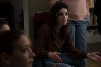 Een vrouw met zwart haar legt iets uit