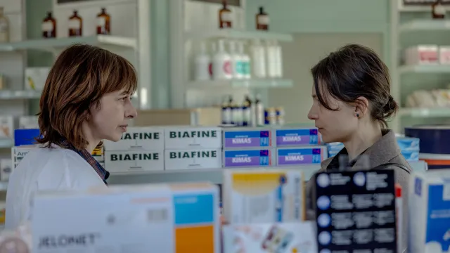 Twee vrouwen praten met elkaar in een apotheek 